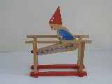 Image of clown perched on its parallel bars
